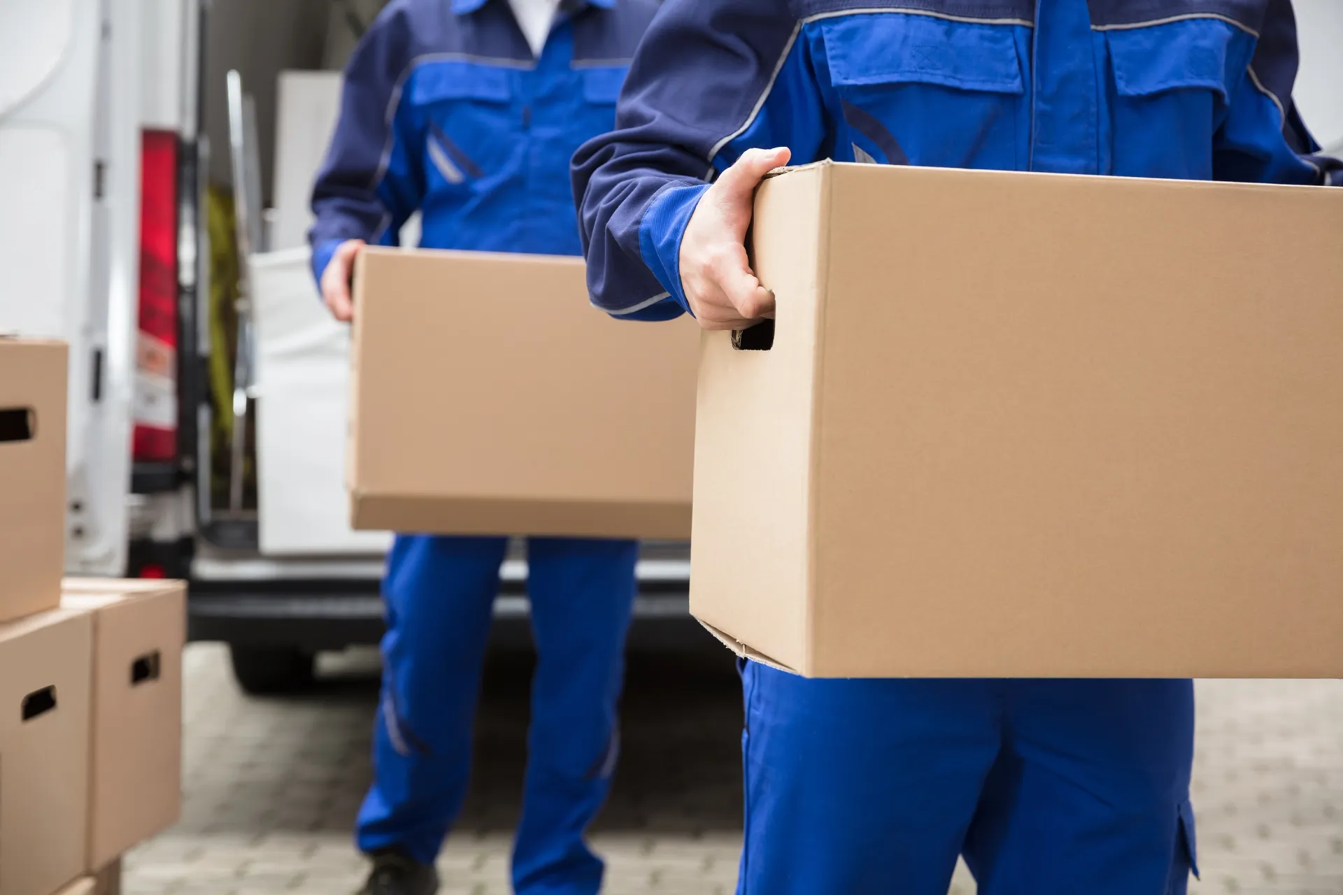 two people holding boxes