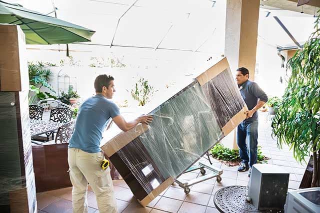 2 people moving a large piece of furniture